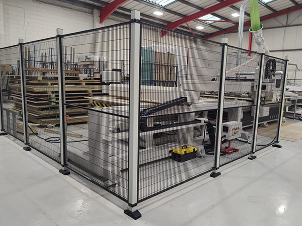 Three-sided safety enclosure mesh fencing around EK Series CNC nesting router installed in UK workshop