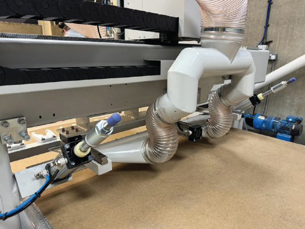Under-gantry spoilboard dust sweeper with extraction hose on EK Series CNC nesting router UK and Ireland